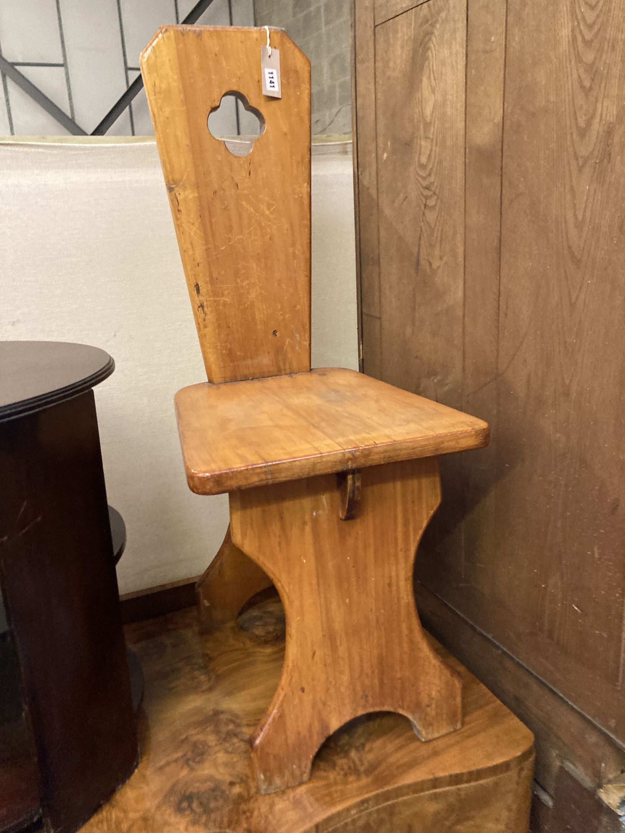 A pair of Italian style pitch pine hall chairs, stamped underneath R.Woolfe and J. Hadaway, width 38cm depth 50cm height 98cm